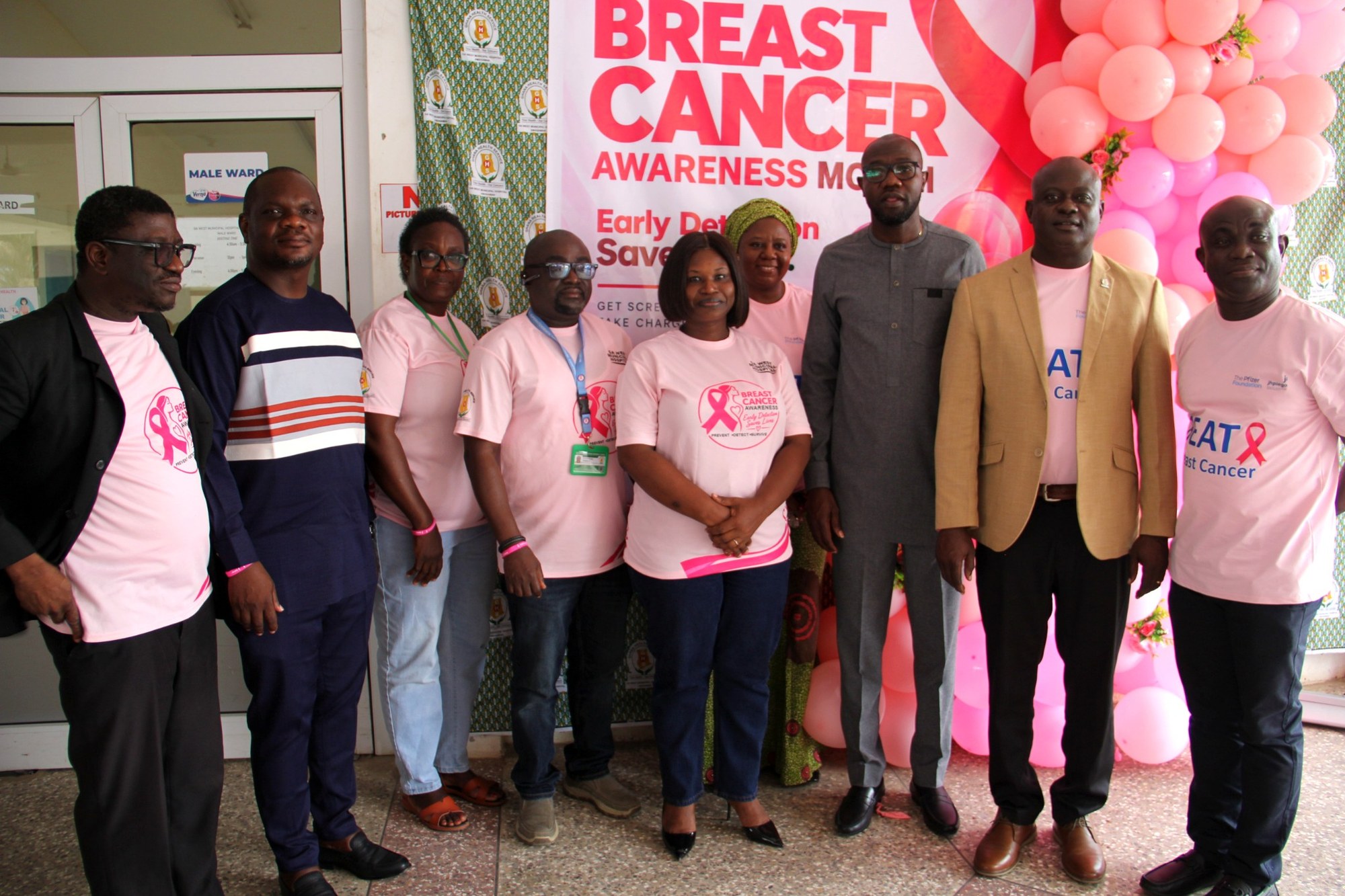Hospital representatives and community dignitaries at the event backdrop