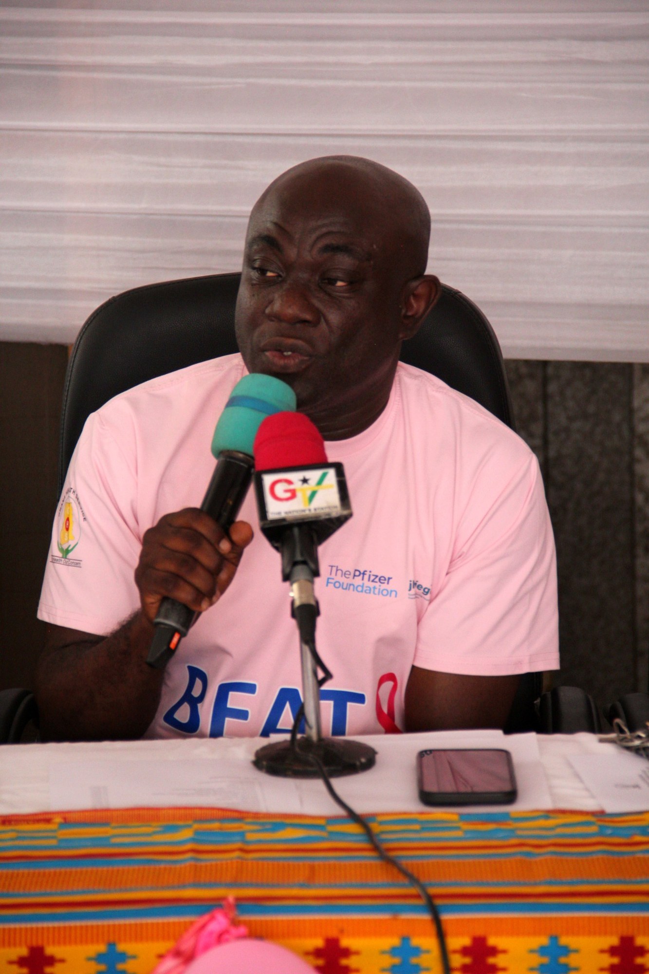 Speaker delivering remarks during the breast cancer awareness programme